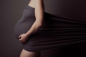 Pregnant woman covered by material